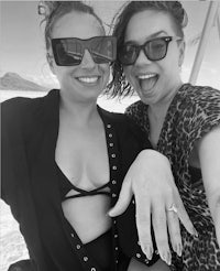 two women posing for a photo with their engagement rings