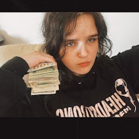 a girl holding a stack of money