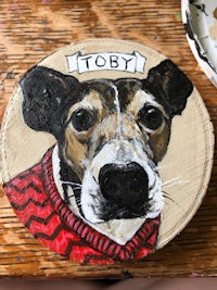 a painting of a dog with the name toby on it