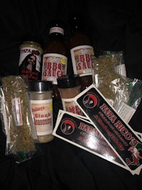a package of hot sauces and seasonings on a bed