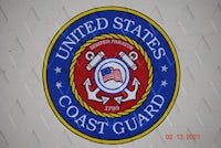 the united states coast guard logo is shown on a white wall