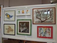 a group of framed pictures on a wall