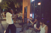 a group of people sitting on a bench at night