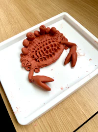 a clay crab on a tray on a table