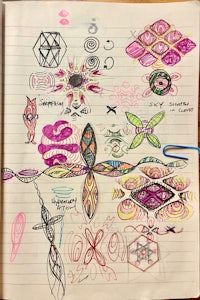 a notebook with a lot of drawings on it