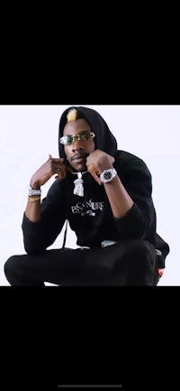 a man in a black hoodie is posing for a picture