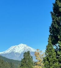 a mountain with snow capped peaks in the background