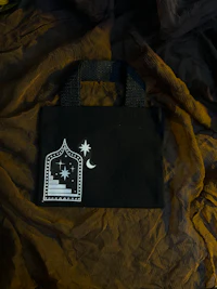 a black bag with a star and moon on it