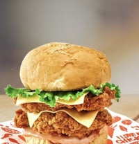 a chicken sandwich is sitting on top of a piece of paper