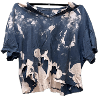 a blue and white tie dye t - shirt hanging on a hanger