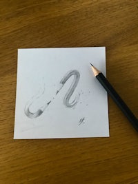a drawing of a snake on a piece of paper