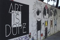 a mural on a wall that says art is dope
