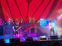 a band performs on stage in a tent