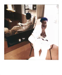 a man sitting in a chair reading a book