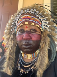 an indian woman wearing a feathered headdress