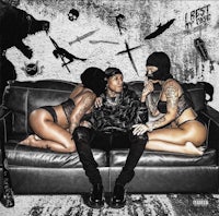 two women sitting on a couch with skulls and knives