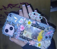 a person holding up a phone case with a picture on it