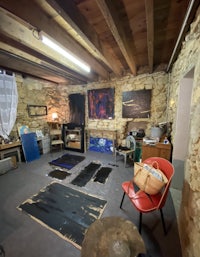 a room with paintings and a chair in it