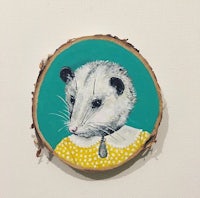 a piece of wood with an opossum on it