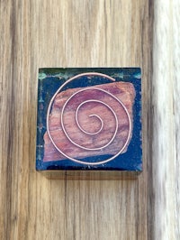 a wooden box with a spiral design on it