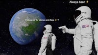 a man in an astronaut suit is pointing a gun at the earth
