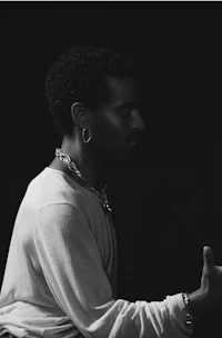 a black and white photo of a man holding a microphone