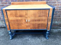 a wooden cabinet with a wooden top and black legs