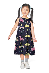a little girl wearing a dress with unicorns and rainbows