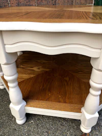 a white coffee table with wooden legs