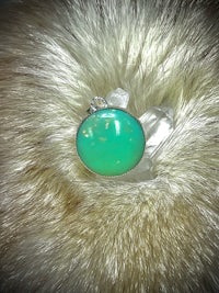 a silver ring with a turquoise stone on it