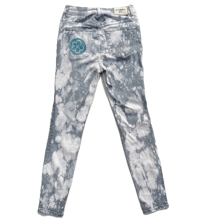 a pair of white and blue tie dyed jeans