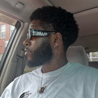 a man sitting in a car wearing sunglasses