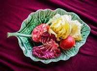 a green leaf on a red cloth