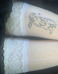 a woman's legs with a tattoo of a bunny on them