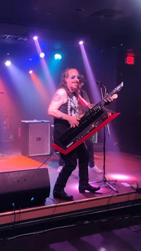 a man playing a keyboard on stage