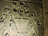 an egyptian relief depicting two men holding a sword