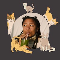 a woman drinking a green juice with cats around her