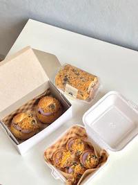 a box of donuts and pastries on a table