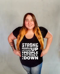 a woman wearing a t - shirt that says strong people up people down
