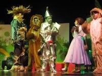 a group of people dressed up in costumes on stage
