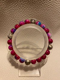 a bracelet with pink and silver beads on it