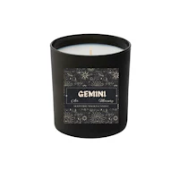 a black candle with the word gemini on it