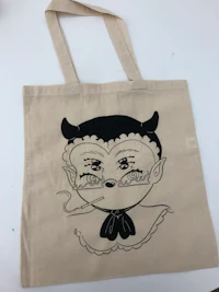 a tote bag with a drawing of a devil