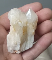 a person holding a piece of quartz in their hand