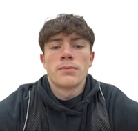 a young man in a black shirt is looking at the camera