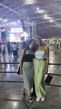two women standing next to each other at a concert