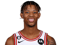 a basketball player with dreadlocks posing for a photo