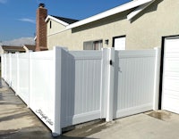 a white fence in front of a house