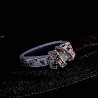 a silver ring with a pink stone on it