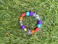 a bracelet with colorful beads on the grass
